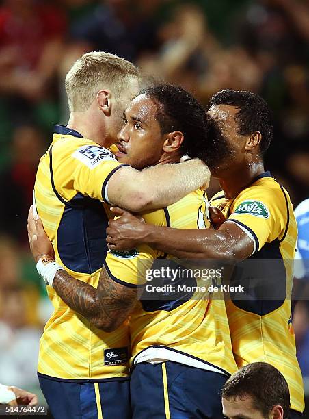 Joe Tomane of the Brumbies celebrates with teammates after scoring a try during the round three Super Rugby match between the Western Force and the...