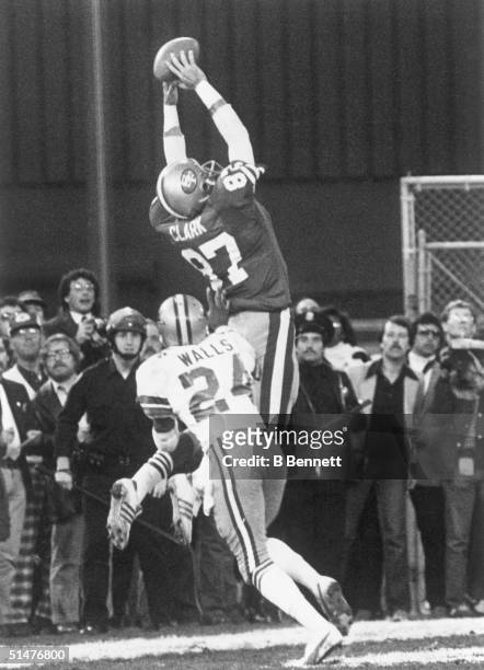 Everson Walls of the Dallas Cowboys is caught out of position as Dwight Clark of the San Francisco 49ers leaps to receive a 6-yard catch of...