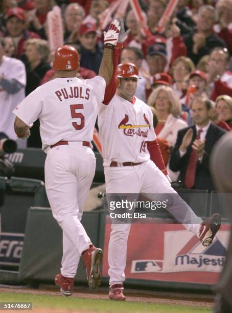 Jim Edmonds of the St. Louis Cardinals congratulates teammate Albert Pujols after hitting a two-run home run against the Houston Astros in Game one...