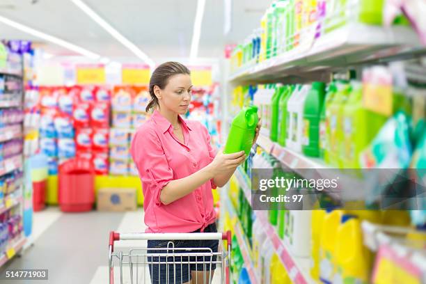 woman buys washing powder - people cleaning at home stock pictures, royalty-free photos & images