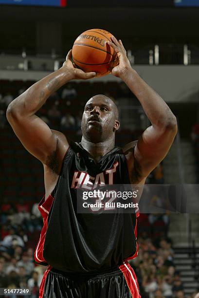 Shaquille O'Neal of the Miami Heat takes a shot during the preseason game with the Houston Rockets at Toyota Center on October 10, 2004 in Houston,...