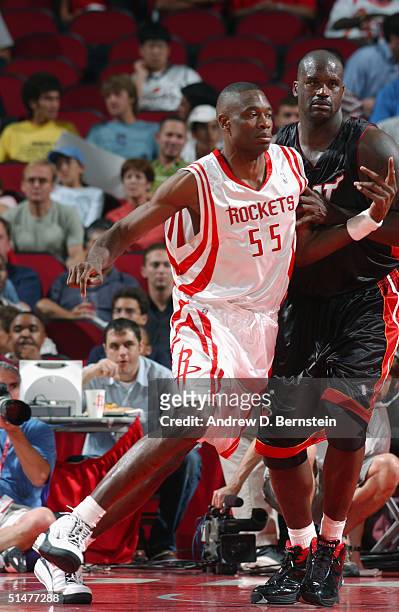 Shaquille O'Neal of the Miami Heat defends against Dikembe Mutombo of the Houston Rockets during the preseason game at Toyota Center on October 10,...