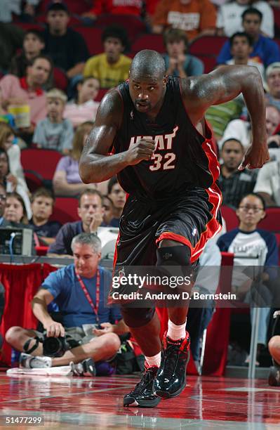 Shaquille O'Neal of the Miami Heat runs on the floor during the preseason game with the Houston Rockets at Toyota Center on October 10, 2004 in...