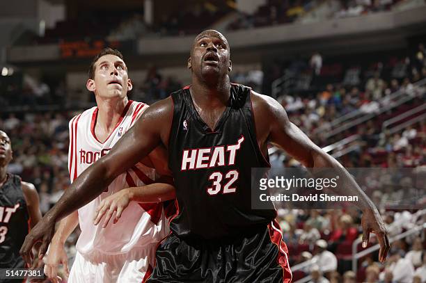 Shaquille O'Neal of the Miami Heat covers Scott Padgett of the Houston Rockets during the preseason game at Toyota Center on October 10, 2004 in...