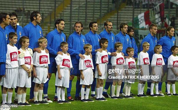 Belarussian children suffering from the affects of the Chernobyl nuclear disaster pose with the Italian team before their World Cup 2006 qualifying...
