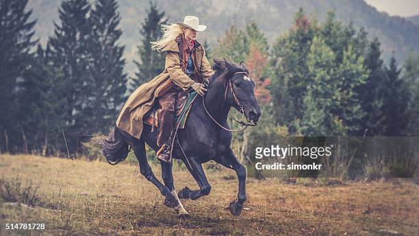woman enjoying horse riding - chaps stock pictures, royalty-free photos & images