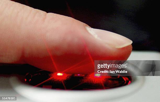 Fingerprint scanner is demonstrated during the Biometrics 2004 exhibition and conference October 14, 2004 in London. The conference will examine the...