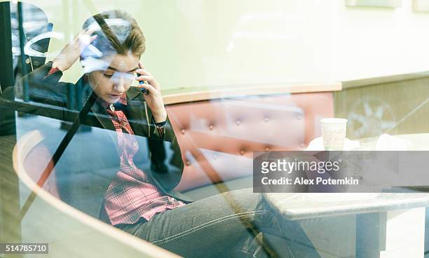 pretty 19-years-old girl talking via cellphne in cafe - 18 19 years photos stock pictures, royalty-free photos & images