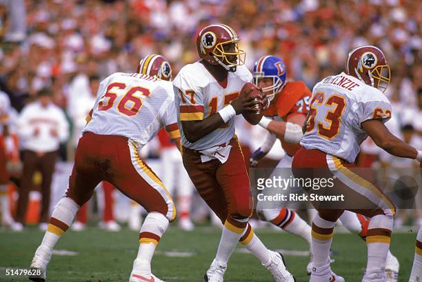 Quarterback Doug Williams of the Washington Redskins drops back to pass during Super Bowl XXII against the Denver Broncos at Jack Murphy Stadium on...