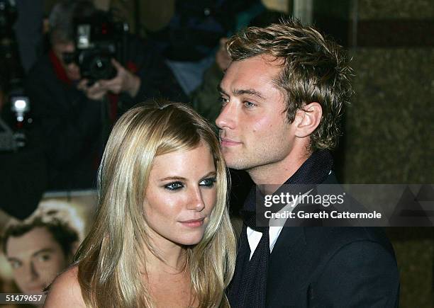Actors Jude Law and Sienna Miller arrive at the World Premiere of "Alfie" at the Empire Leicester Square on October 14, 2004 in London.