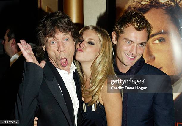 Singer Mick Jagger and actors Sienna Miller and Jude Law arrive at the World Premiere of "Alfie" at the Empire Leicester Square on October 14, 2004...