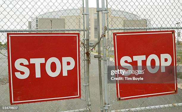 Locked gate between two large square Stop signs is seen at the United Center, home of the NHL Chicago Blackhawks hockey team October 14, 2004 in...