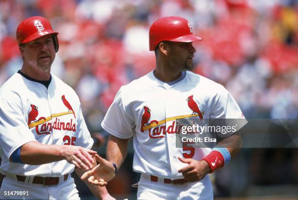 Albert Pujols of the St. Louis Cardinals is congratulated by teammate Mark McGwire during the game against the Chicago White Sox at Busch Stadium on...