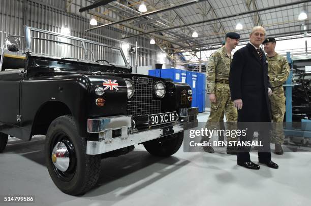 Prince Philip, Duke of Edinburgh , Colonel-in-Chief, Royal Electrical and Mechanical Engineers , looks at a Black 1960s ceremonial Land Rover Series...