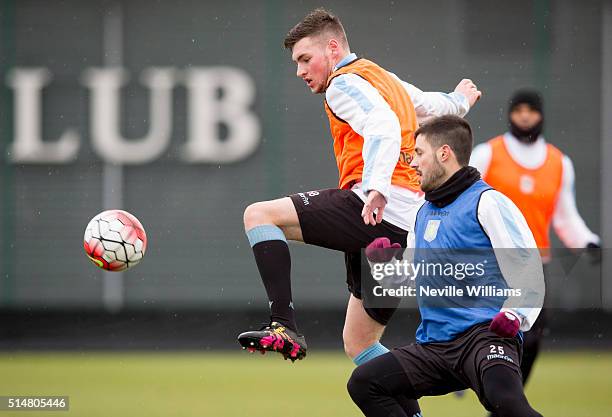 Kevin Toner of Aston Villa in action with team mate Carles Gil during a Aston Villa training session at the club's training ground at Bodymoor Heath...