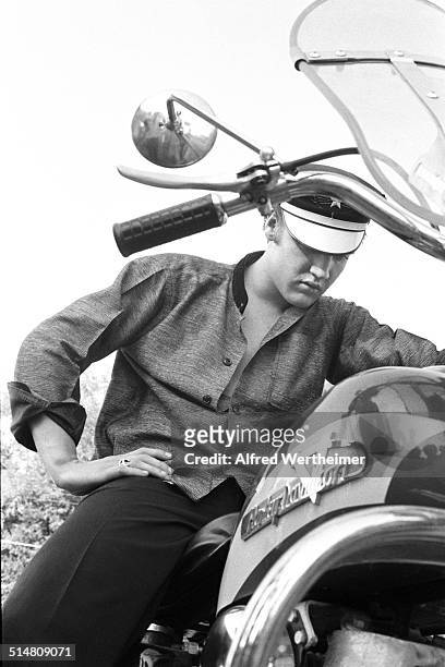Alfred Wertheimer/MUUS Collection via Getty Images) View of American musician Elvis Presley as he sits his Harley-Davidson motorcyle, Memphis,...