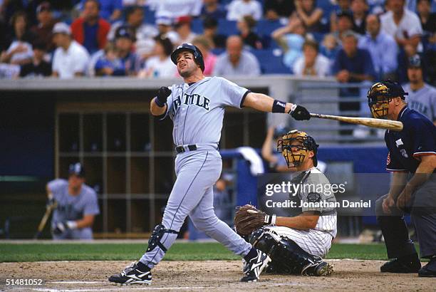 Edgar Martinez of the Seattle Mariners watches the flight of the ball as he follows through on his swing during a game against the Chicago White Sox...