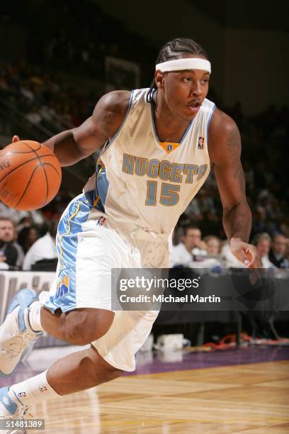Carmelo Anthony of the Denver Nuggets drives against the Milwaukee Bucks on October 14, 2004 at the World Arena in Colorado Springs, Colorado. NOTE...