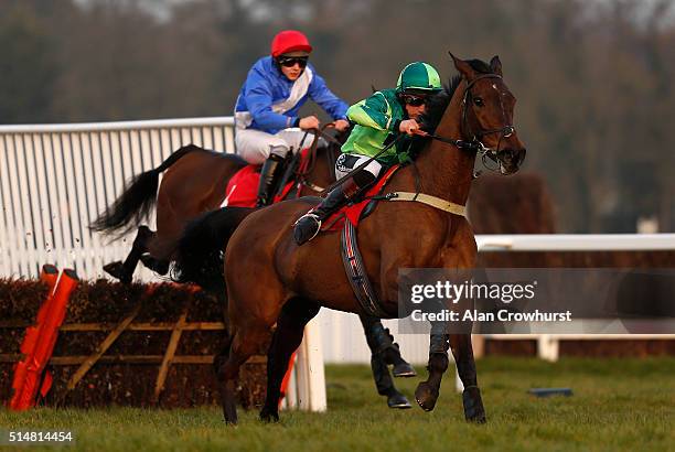 Jamie Moore riding Bagging Turf clear the last to win The Anne Boleyn Mares' Novices' Hurdle Race at Sandown racecourse on March 11, 2016 in Esher,...