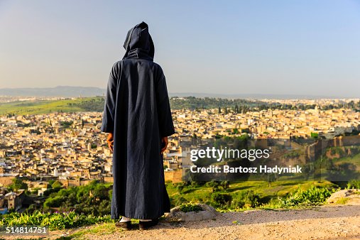 Moroccan man looking at medina of Fez Moroccan man looking at medina of Fez