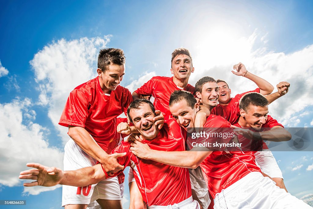 Successful soccer team against the sky.