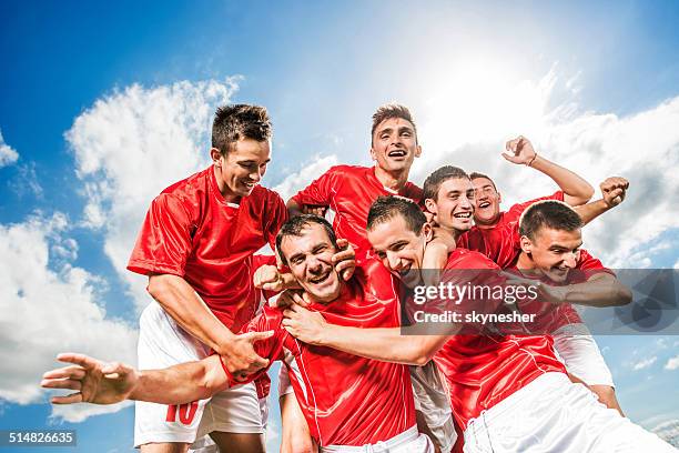 successful soccer team against the sky. - mens soccer team stock pictures, royalty-free photos & images