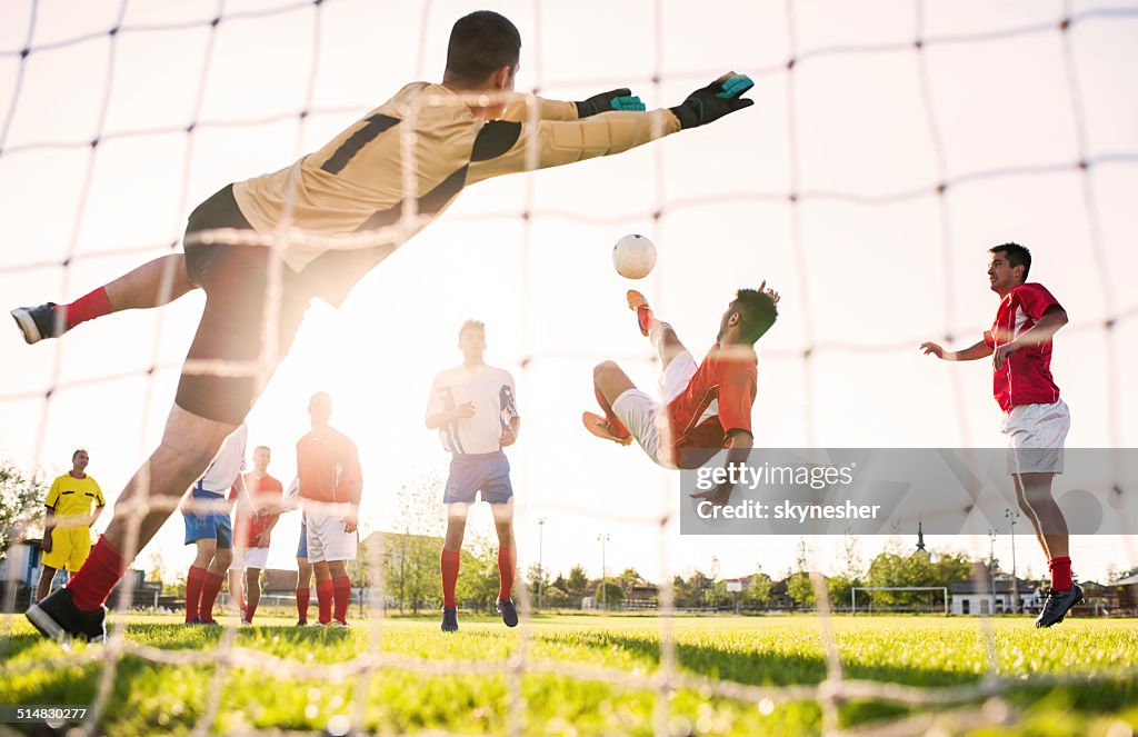 Playing soccer at sunset.