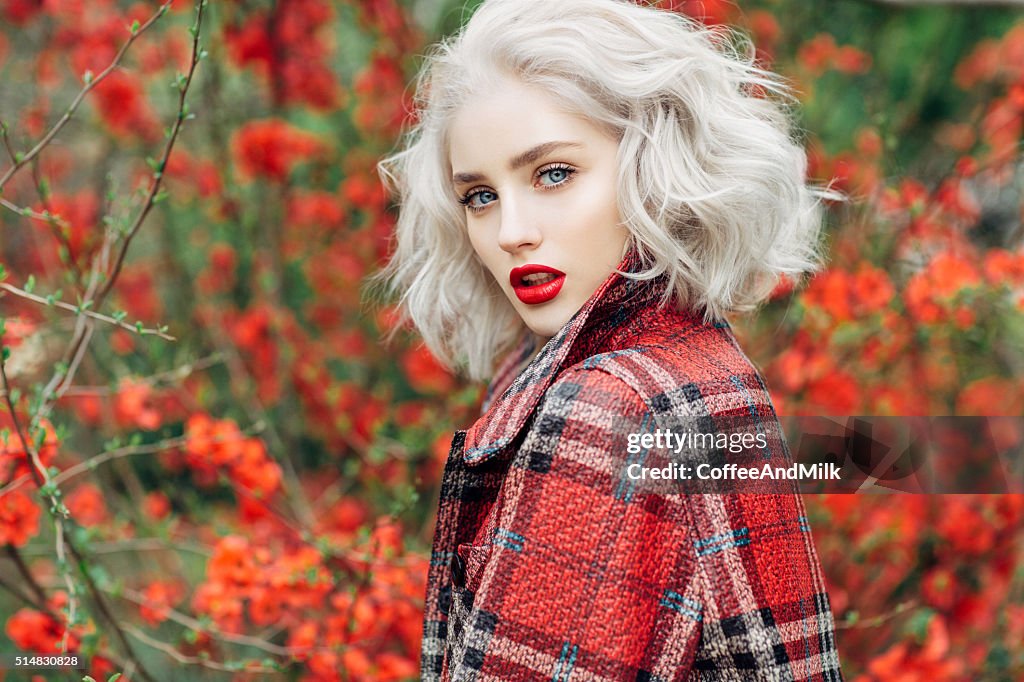 Beautiful girl on the background of spring bush