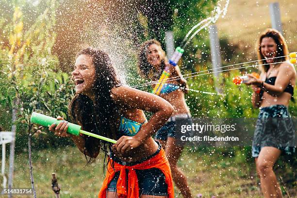 water gun fight - friends fighting stock pictures, royalty-free photos & images