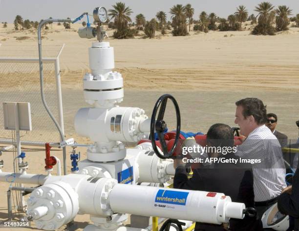 German Chancellor Gerhard Schroeder and Libyan Prime Minister Shukri Mohammed Ghanem open an oil drilling well operated by German company Wintershall...