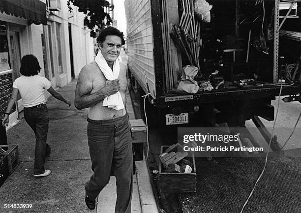 Shirtless, American actor and director Cliff Robertson smiles as he walks to an equipment trailer between takes of his film 'The Pilot,' West Palm...