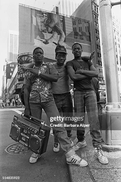 Three teenage boys pose together in Times Square, New York City, USA, 1987.