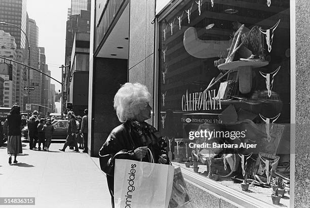 Woman looks at a California themed window display at Bloomingdale's department store, New York City, USA, 11th April 1989.