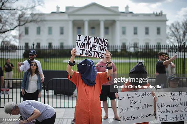 Loyola University Chicago students demonstrating for human dignity are joined by people protesting against the military prison at Guantanamo Bay...