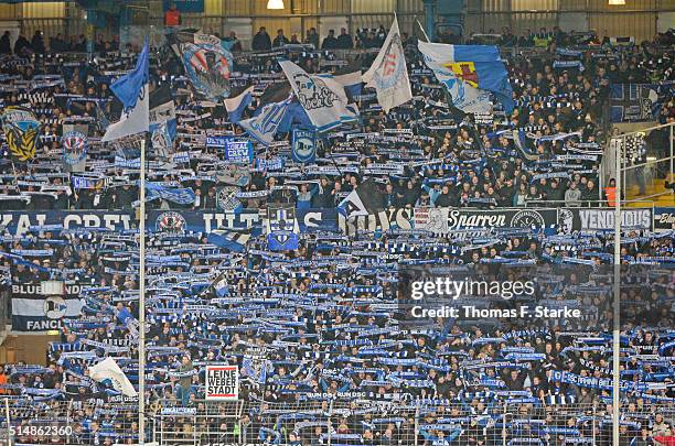 Supporters of Bielefeld cheer their team during the Second Bundesliga match between Arminia Bielefeld and 1. FC Nuernberg at Schueco Arena on March...