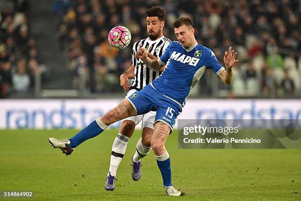 Sami Khedira of Juventus FC turns Francesco Acerbi of US Sassuolo Calcio during the Serie A match between Juventus FC and US Sassuolo Calcio at...