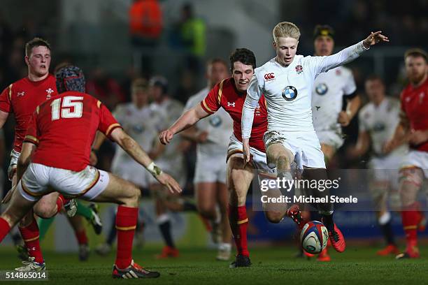 Mat Protheroe of England U20 kicks ahead under pressure from Daniel Jones of Wales U20 during the Six Nations match between England U20 and Wales U20...