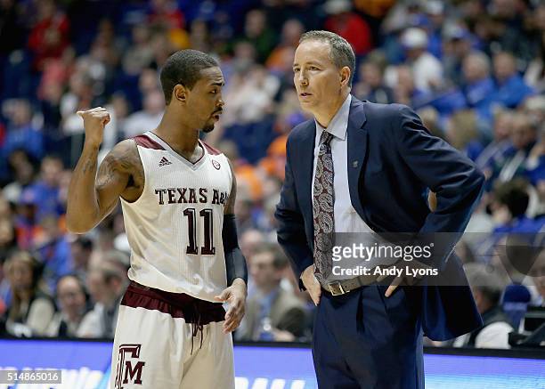 Anthony Collins of the Texas A&M Aggies talks to Billy Kennedy the head coach in the game against the Florida Gators during the quarterfinals of the...