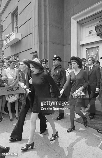 Judy Garland's daughter, Liza Minnelli, carries a small basket of flowers as she leaves funeral home following services June 27 for her famous mother.