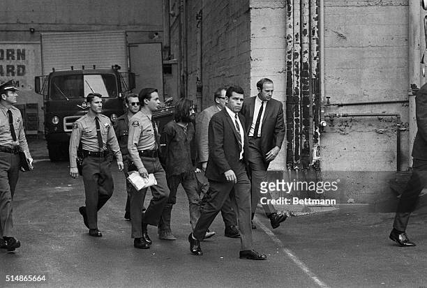 Los Angeles: Charles Manson, accused leader of a hippie cult charged with the Tate-LaBianca murders, is heavily guarded as he leaves the Hall of...