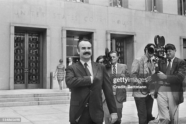 Former White House aide G. Gordon Liddy is filmed by journalists as he leaves U. S. District Court, where he pleaded Not Guilty of breaking into...