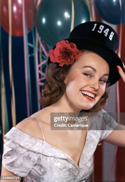 Smiling woman wearing new years eve party hat of 1948, Los Angeles, California, 1949.