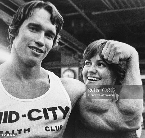 Arnold Schwarzenegger supplies a chinrest for Sally Field as they take a break from a bodybuilding workout session here 4/20. They began the exercise...