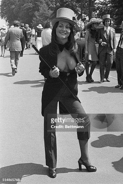 Top hat, tails and cane are some of the weapons actress Linda Lovelace uses to compete in the unofficial fashion "race" at the Royal Ascot Race...