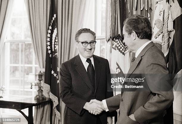 Washington:Pres. Nixon congratulates Secy. Of State Henry A. Kissinger for winning the Nobel Peace Prize 10/16. Kissinger shared the prize with North...