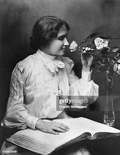 American writer and lecturer Helen Keller takes time to smell a rose. Due to illness, Keller suffered loss of sight and hearing at the age of 19...