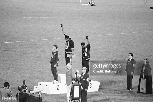 Tommie Smith and John Carlos, gold and bronze medalists in the 200-meter run at the 1968 Olympic Games, engage in a victory stand protest against...