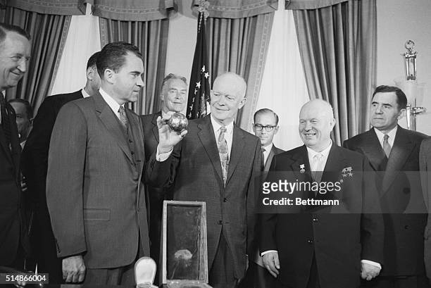 President Eisenhower holds a replica of the small sphere that landed on the moon as part of the Russian Lunik Rocket. The sphere was presented to him...
