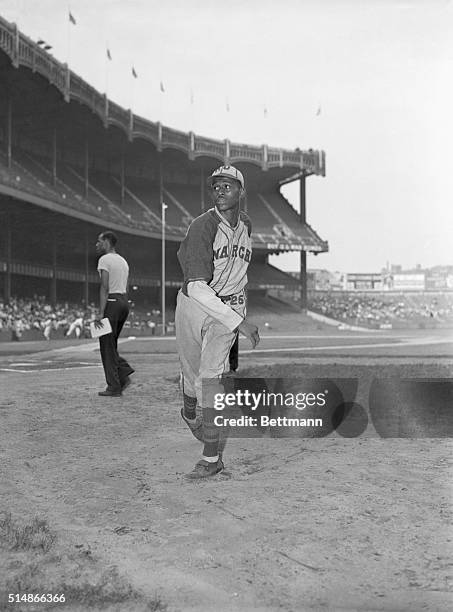 Hall of Fame pitcher Satchel Paige throws before a game. He wears the uniform of the Kansas City Monarchs, a team in the Negro National League.