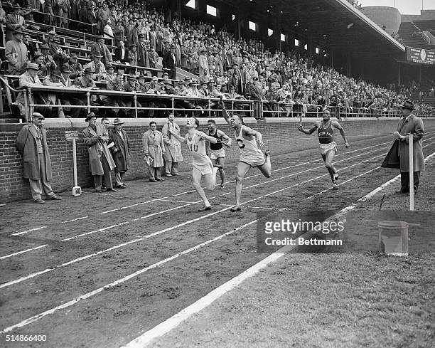 Philadelphia, PA: Ira Kaplan of New York University is shown breasting the tape as his school won the one-half mile college relay championship at...